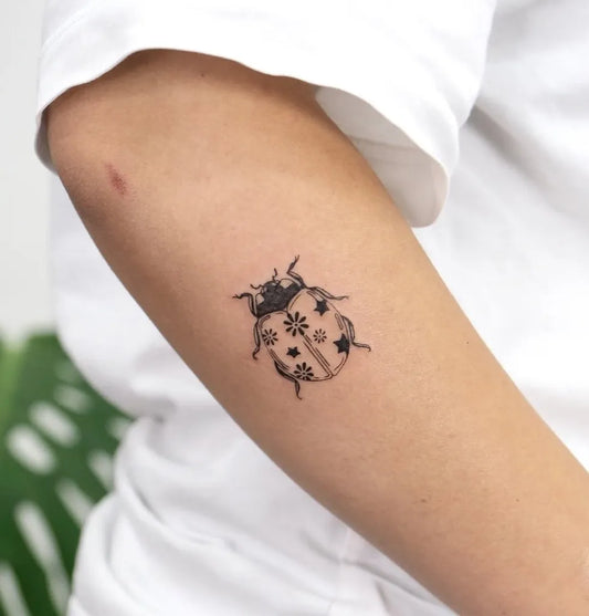 Small Fine Line Ladybug Tattoo on Women Arm by @tattoosanatevi