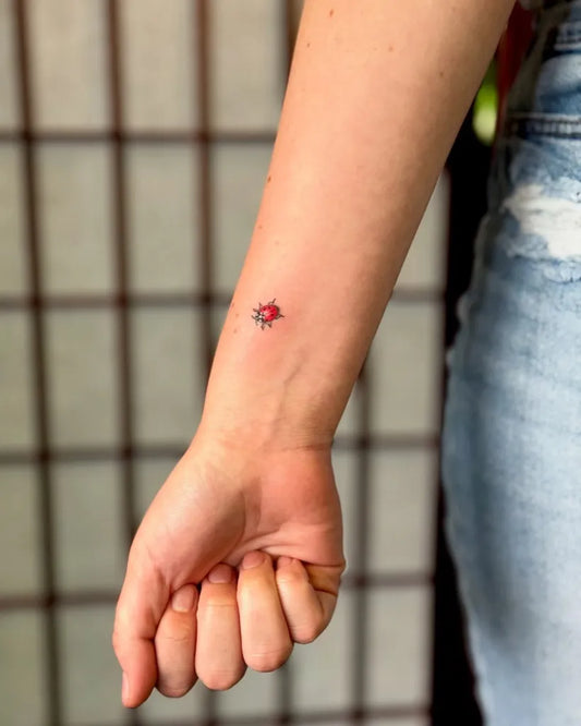 Small Fine Line Ladybug Tattoo on Women Wrist by @diegoflores.art