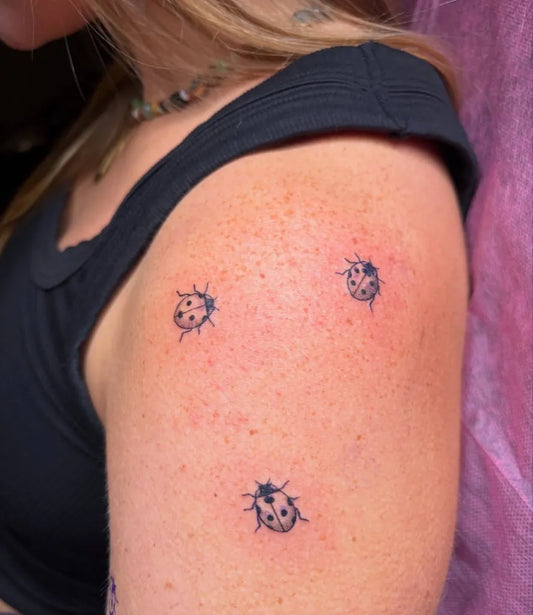 Small Fine Line Ladybugs Tattoo on Women Shoulder by @elena.tattooed