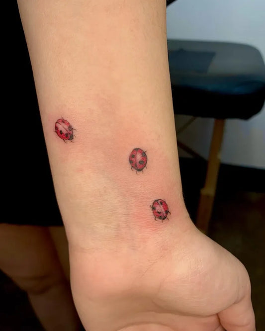 Small Fine Line Ladybugs Tattoo on Women Wrist by @vmontes_
