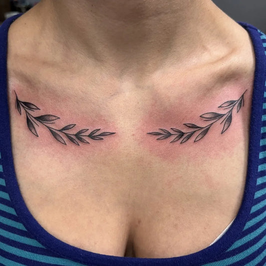 Small Fine Line Laurel Branches Tattoo on Women Collarbone by @studio13_crawley