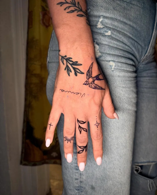 Small Fine Line Laurel Swallow Cross on Women Hand Tattoo by @sobtattoo