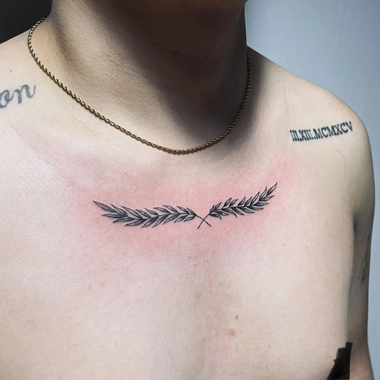 Small Fine Line Laurel Wreath Tattoo on Men Chest by @kier.tattoo
