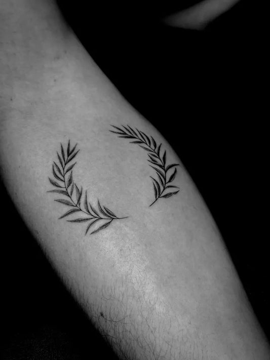 Small Fine Line Laurel Wreath Tattoo on Women Forearm by @laraskillz