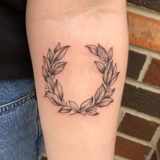 Small Fine Line Laurel Wreath Tattoo on Women Forearm by @wtc13