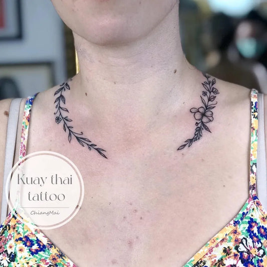 Small Fine Line Laurel Wreath with Flowers Tattoo on Women Neck by @kuaythaitattoo