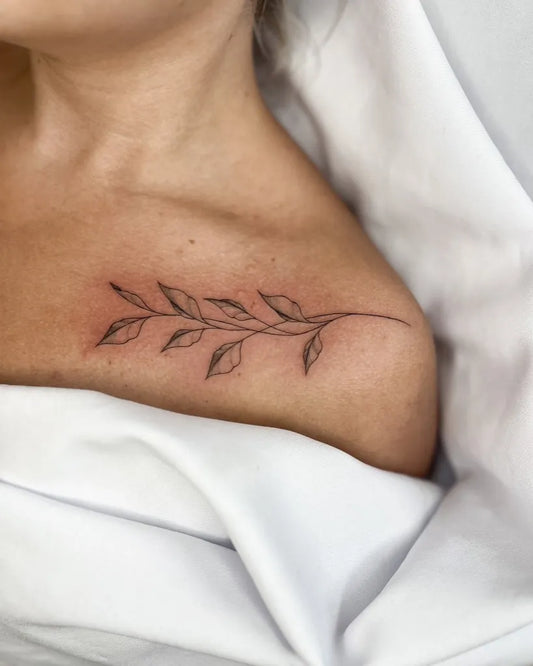 Small Fine Line Leaf Branch Tattoo on Women Collarbone by @jola.tattoo