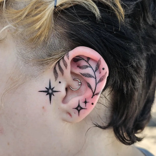 Small Fine Line Leaves and Stars Tattoo on Women Behind the Ear by @bugdylantattoo