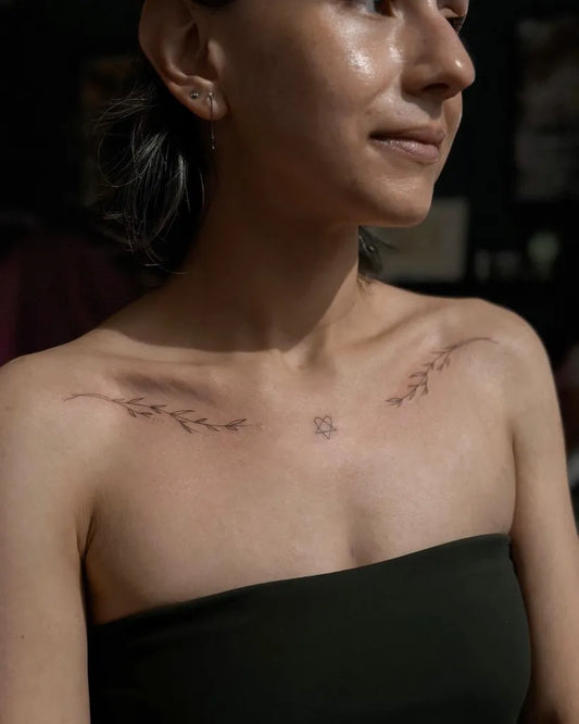 Small Fine Line Leaves and Symbol Tattoo on Women Collarbone by @bhc.newyork