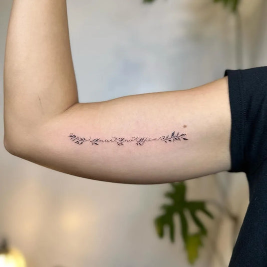 Small Fine Line Leaves and Word Tattoo on Women Inner Arm by @amberproject.ph