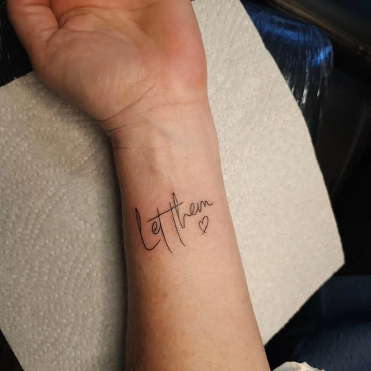 Small Fine Line Let Them Text Heart on Women Wrist Tattoo by @edee.bad_influence_tattoos