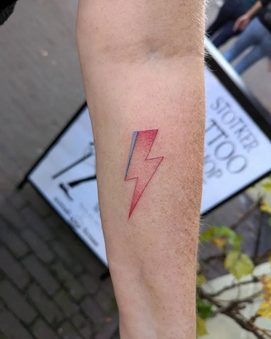 Small Fine Line Lightning Bolt Tattoo on Women Arm by @just.does.dots