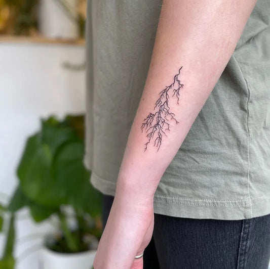 Small Fine Line Lightning Bolt Tattoo on Women Forearm by @umatattoos