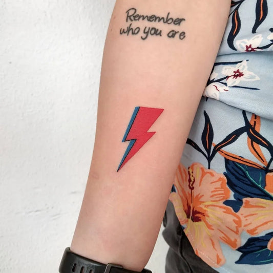 Small Fine Line Lightning Bolt and Text Tattoo on Women Arm by @cosmobotic