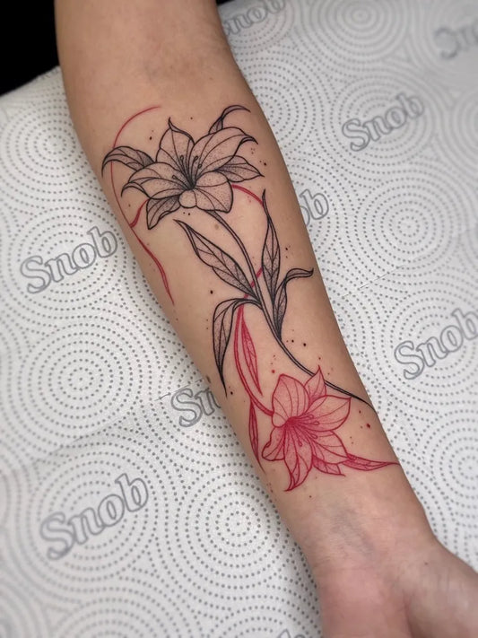 Small Fine Line Lily Flower and Leaves on Women Arm Tattoo by @andrewsctattoo
