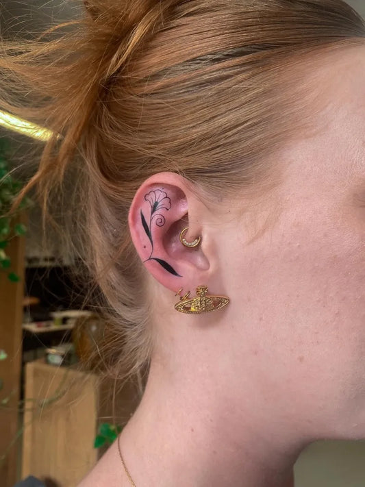 Small Fine Line Lily Flowers Tattoo on Women Behind the Ear by @maye.sh