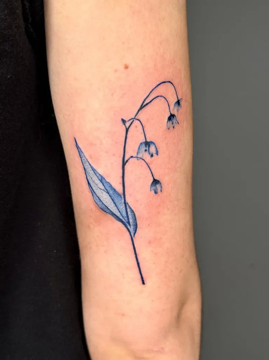 Small Fine Line Lily of the Valley Spiritual Tattoo on Women Arm by @local_p0ke