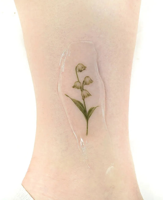 Small Fine Line Lily of the Valley Women Leg Tattoo by @eontattoo