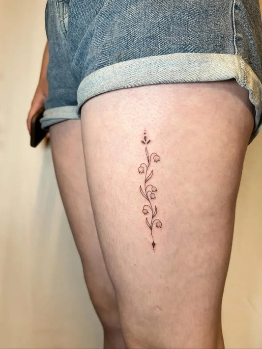 Small Fine Line Lily of the Valley Women Thigh Tattoo by @daisy.pokes