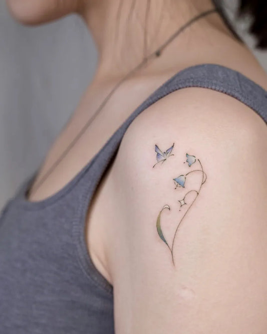 Small Fine Line Lily of the Valley and Hummingbird on Women Shoulder Tattoo by @uwendyxx.tat