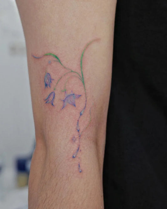 Small Fine Line Lily of the Valley on Women Arm Tattoo by @renuue_ink