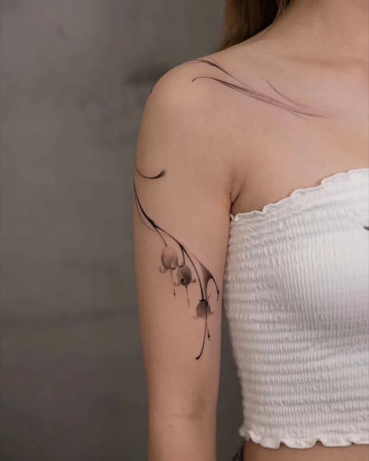 Small Fine Line Lily of the Valley on Women Shoulder Tattoo by @newtattoo_studio