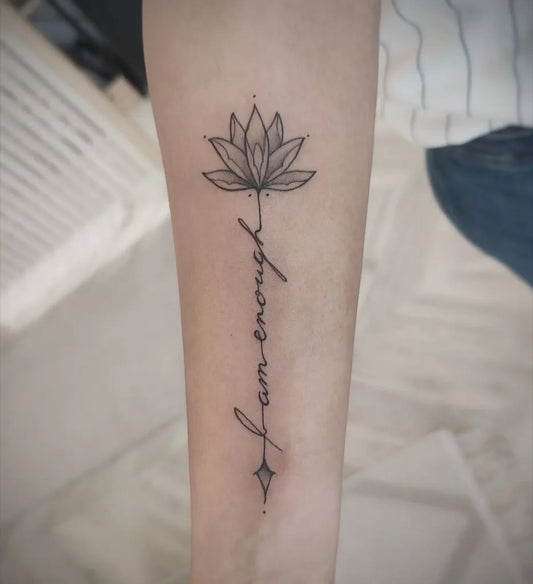 Small Fine Line Lotus Flower Enough Script on Women Forearm Tattoo by @annakaisa_havenink