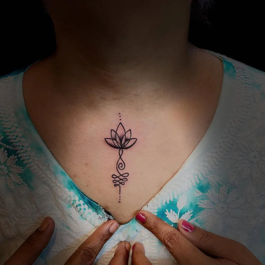 Small Fine Line Lotus Flower Om Symbol on Women Chest Tattoo by @sam_tattoosindia