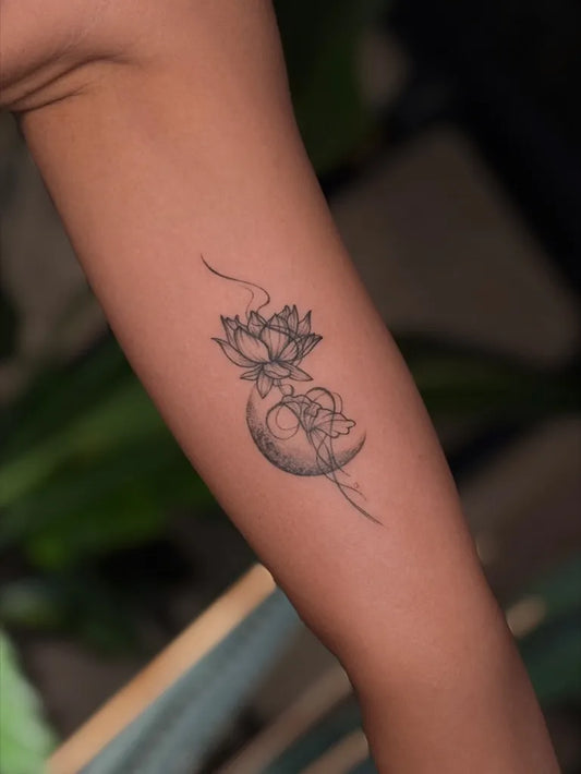 Small Fine Line Lotus Flower and Crescent Moon on Women Forearm Tattoo by @owho.tattoo
