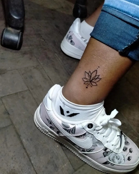 Small Fine Line Lotus Flower on Women Ankle Tattoo by @claatyfranklin