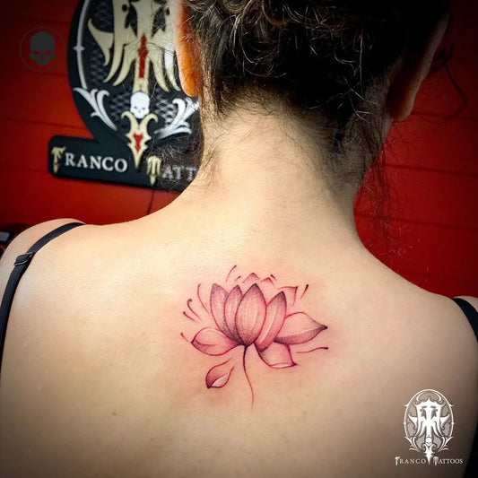 Small Fine Line Lotus Flower on Women Back Tattoo by @franco_tattoos_