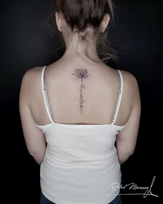 Small Fine Line Lotus Flower on Women Back Tattoo by @robertiberiu