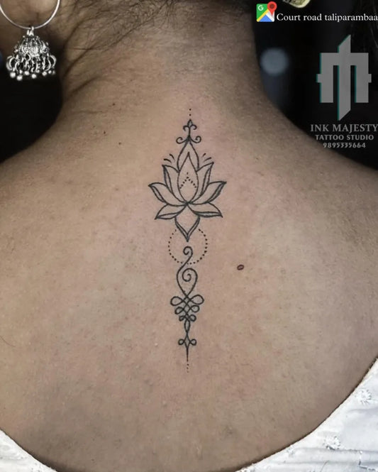 Small Fine Line Lotus Flower on Women Back Tattoo by @tattoo_ink_majesty_taliparamba