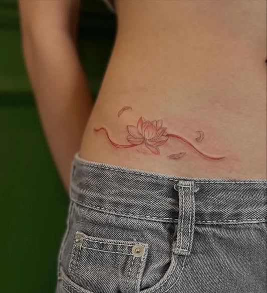 Small Fine Line Lotus Flower with Feathers and Waves on Women Hip Tattoo by @roxietattoos