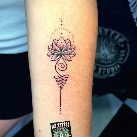 Small Fine Line Lotus Flower with Unalome on Women Forearm Tattoo by @ibu_tattoo