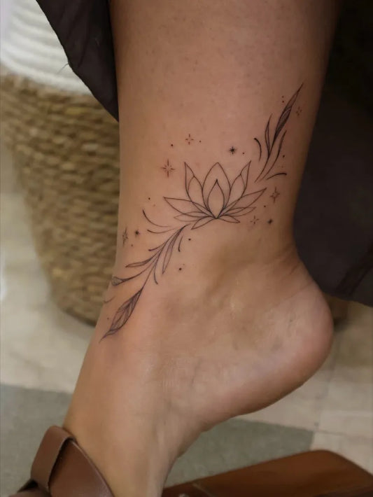 Small Fine Line Lotus Flowers Tattoo on Women Ankle by @tragtattoo