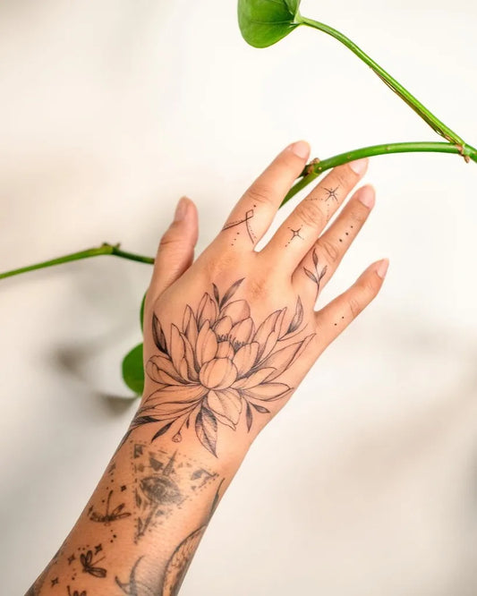 Small Fine Line Lotus Flowers on Women Hand Tattoo by @inkingcali