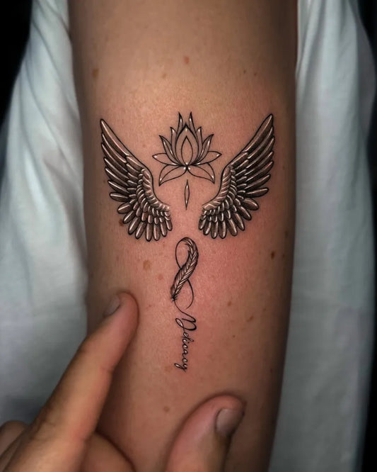 Small Fine Line Lotus with Angel Wings and Infinity Tattoo on Women Arm by @cachotattoo