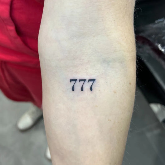 Small Fine Line Lucky Number 777 Tattoo on Women Arm by @korczlivia_tattoo