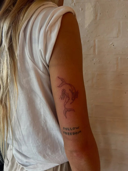 Small Fine Line Mermaid Tattoo on Women Arm by @emreidtattoo