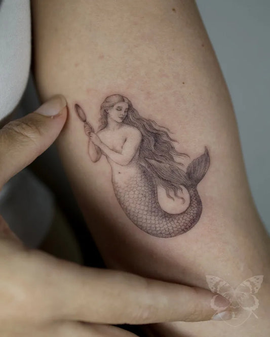 Small Fine Line Mermaid Tattoo on Women Arm by @federicafratinitattoo