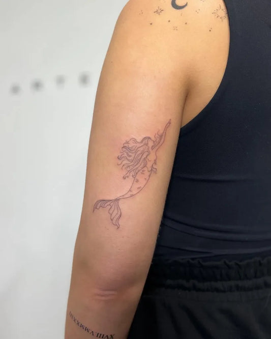 Small Fine Line Mermaid Tattoo on Women Arm by @lucie.tattoo