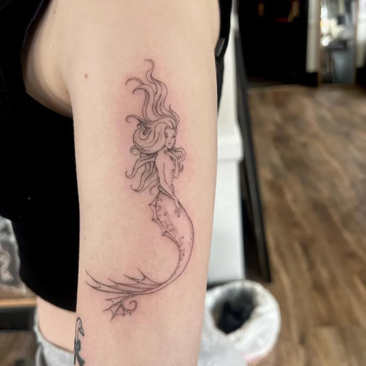 Small Fine Line Mermaid Tattoo on Women Arm by @melrossdesigns