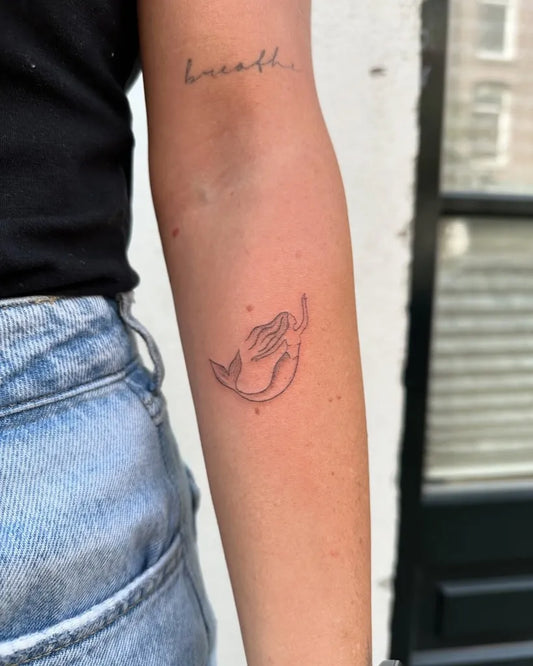 Small Fine Line Mermaid Tattoo on Women Arm by @wavylevi_