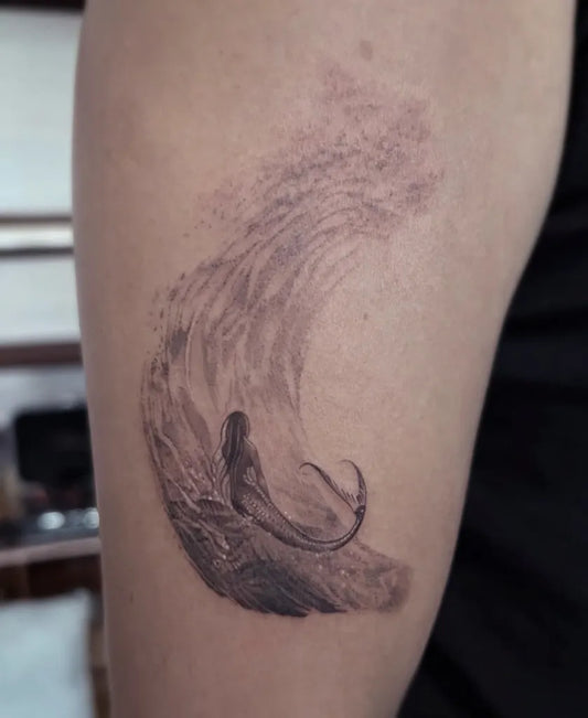 Small Fine Line Mermaid Wave Tattoo on Women Arm by @seahdeborah