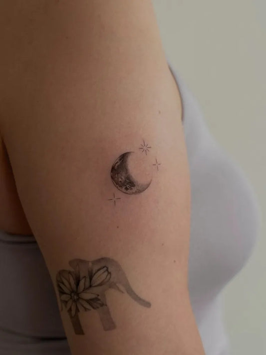 Small Fine Line Moon Elephant Tattoo on Women Arm by @onyx.studiotattoo