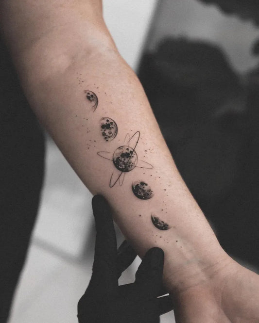 Small Fine Line Moon Phases Planets Tattoo on Women Arm by @ink.your.universe