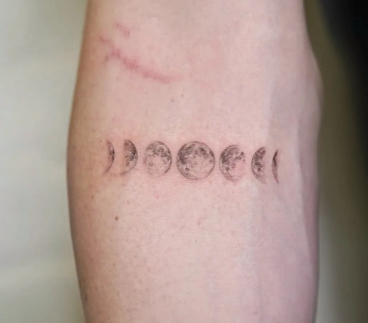 Small Fine Line Moon Phases Tattoo on Women Forearm by @tattooartbyhailey