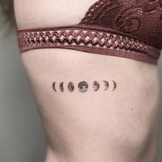 Small Fine Line Moon Phases Tattoo on Women Rib by @laiamovellantattoo