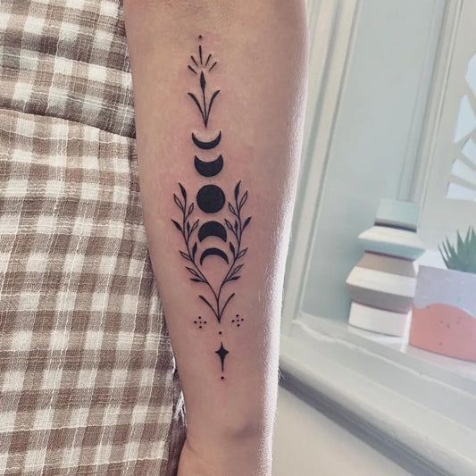Small Fine Line Moon Phases and Leaves Tattoo on Women Arm by @sandra.o.tattoo